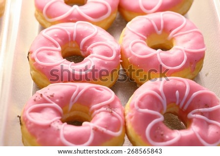 Pink donut on  shelf / Pink donut