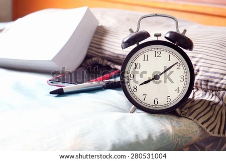 Alarm clock on bed at home / Alarm clock
