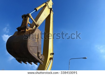Bucket of tracked excavator against blue sky / Bucket of tracked excavator