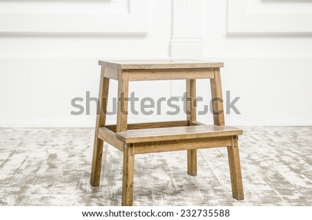 small natural wooden ladder chair, isolated on wooden floor