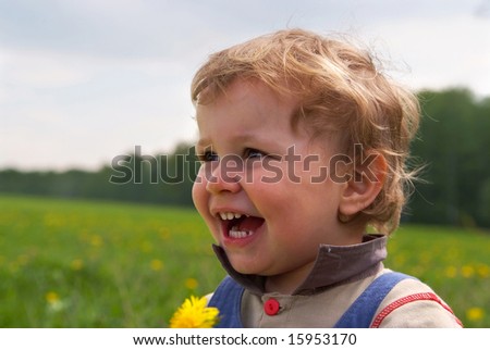 little boy with dandelion in hand