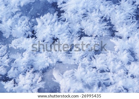 Ice flakes on blue frozen background