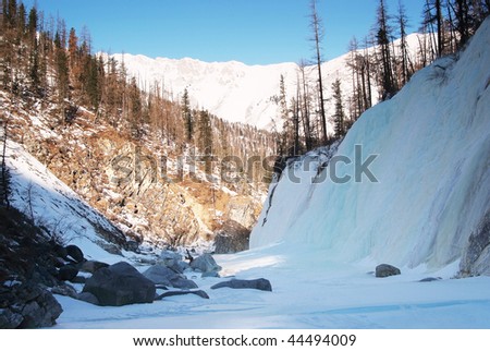 Frozen waterfall in mountain of Altai. Siberia. Russia