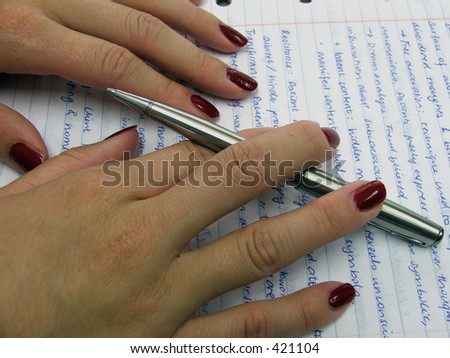 Proof reading a paper with pen in hand
