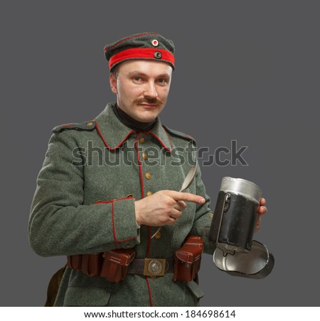 German infantryman during the first world war. Soldier with a bowler for food. WWI. Isolated on gray.