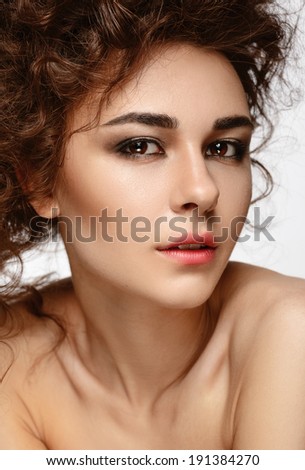 Beautiful girl with careless makeup on her lips. Clean skin. Dark eyes. A sensual look.
