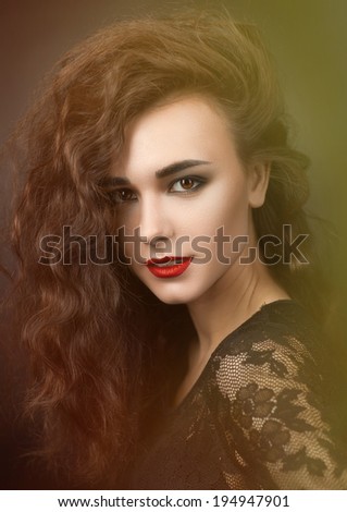 Beauty Portrait of a girl with red lipstick and fluffy hair