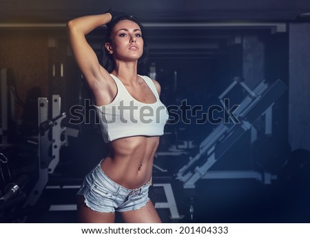Young sexy woman after workout in gym.