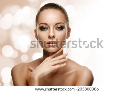 Beauty Portrait. Beautiful Woman Touching her Face. Perfect Fresh Skin. Pure Beauty Model. Youth and Skin Care Concept