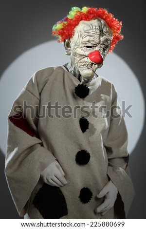 Portrait of sad clown with red nose. Halloween Costume.