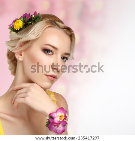 Beautiful girl with hair and a flower in her hair. Beauty Model Woman Face. Perfect Skin. Professional Make-up. Makeup.