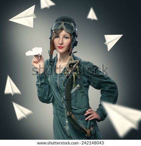 Woman pilot, playing with paper airplanes.