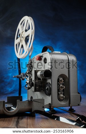 Retro Movie projector with the film on the wooden floor.