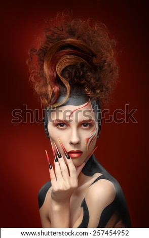 Beautiful fashion woman color face art fenix style and nail design