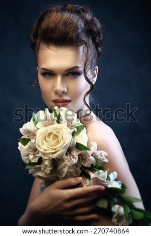 Gorgeous Brunette bride with wedding bouquet. Instagram toned. Shallow depth of field.