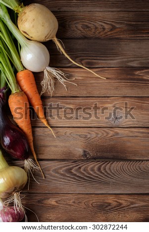 Fresh vegetables on a wooden table. Rustic style. Vegetarianism. Organic food. Space for text.
