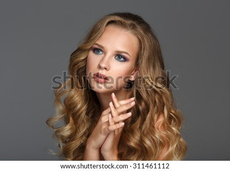 Beautiful Woman with Curly Long Hair. Color makeup.
