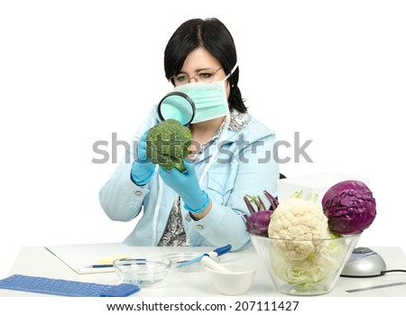 Quality control expert carefully inspecting a broccoli with magnifying glass in laboratory