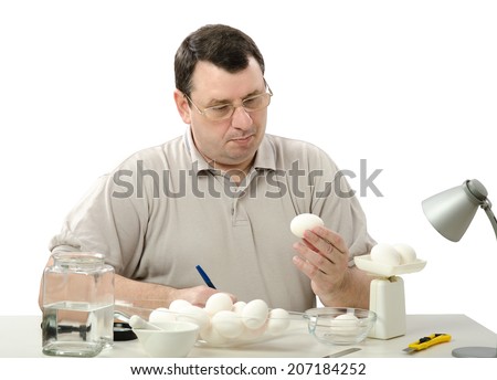 Quality control expert carefully analyzes eggs in the laboratory