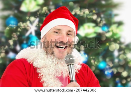 Cheerful mature fat man in Santa Claus costume singing Christmas songs with microphone