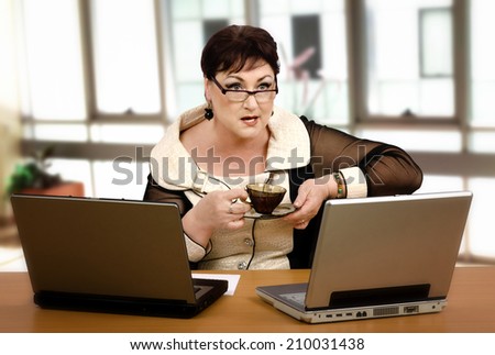 Middle-aged office employee has received notification to termination on-line while she drinking coffee cup