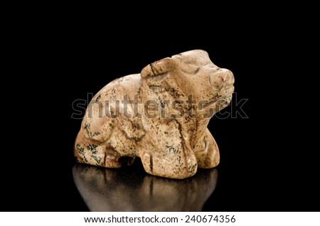 Hand carved picture jasper ox on black background. Chinese sign Ox occupying the second position on the Chinese Zodiac