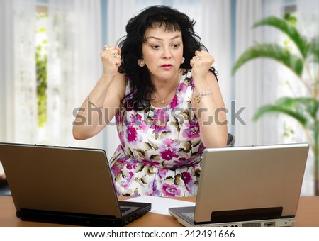 Mature woman talking to someone on the internet is very irritated
