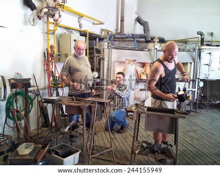 Czech countryside, Czech Republic - September 28, 2014: Unidentified glass makers are working in small glassblowing studio
