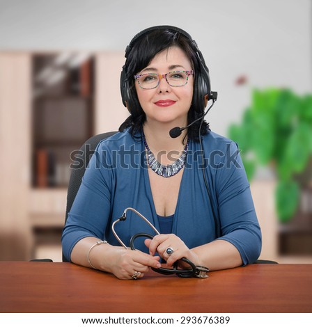 Middle aged medical recruiter in headset is interviewing candidates by on-line video chat