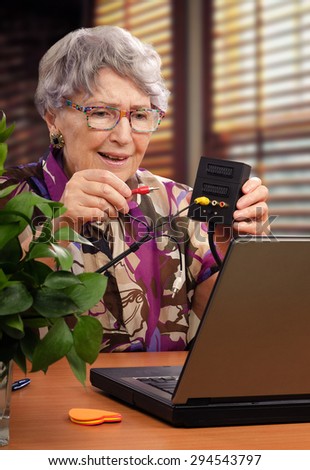 Old woman is trying to search information about audio video adapter in internet