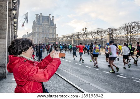 PARIS - APRIL 7: Parisians and guests celebrate the 37th annual marathon on the Rue de Rivoli near the Louvre on April 7, 2013 in Paris, France.