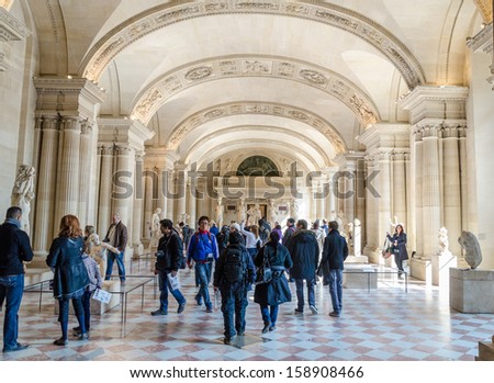 PARIS - APRIL 07: Tourists walk in Museum Louvre on April 07, 2013 in Paris, France