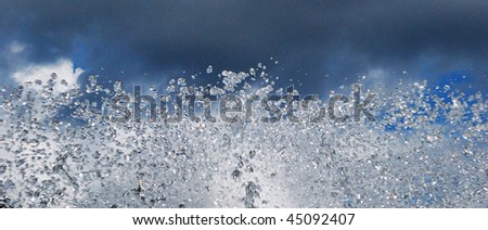 sparks of water on a background grey sky