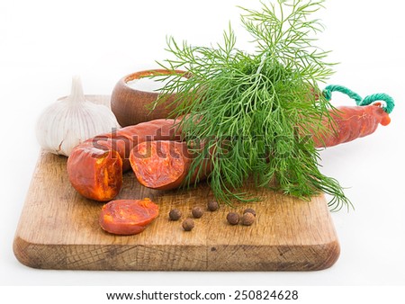 Rustic still life with sausage, garlic and herbs Focus area increased by folding multiple photos