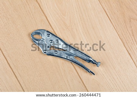 Locking pliers embossed on the wooden floor
