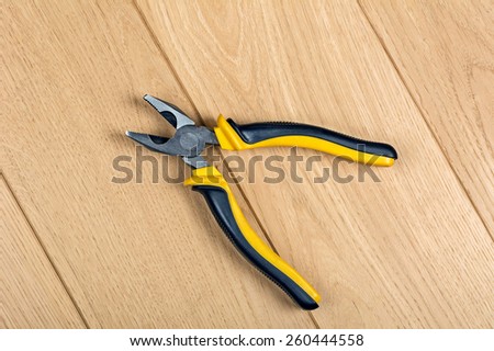 pliers embossed on the wooden floor