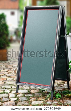 Empty menu board standing on the street and  blured background