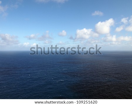 Ocean and Cloud scape with a jagged shadow on the water in the Pacific Ocean.