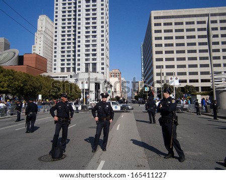 SAN FRANCISCO, CA - OCTOBER 25: SFPD Police officers stand on blocked street as protesters of Marijuana rights stand behind fence along Howard street on October 25, 2011 in San Francisco.