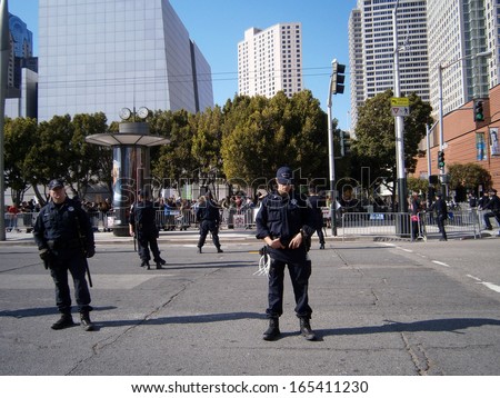 SAN FRANCISCO, CA - OCTOBER 25: SFPD Police officers stand on street as protesters of Marijuana rights stand behind fence along Howard street on October 25, 2011 in San Francisco.