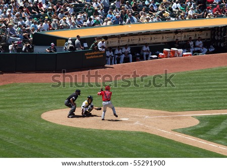 OAKLAND - JUNE 10: Angels vs. A\'s: Angels Hideki Matsui lifts foot as he prepares to swing with A\'s Kurt Suzuki catching and an umpire standing behind him.  June 10 2010 Oakland coliseum California