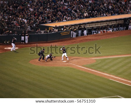 OAKLAND, CA - JULY 7: Yankees 6 vs A's 2: A's Kurt Suzuki at bat with banded aid under his chin from a ball that bounced off his face earlier.  July 7 2010 at the Coliseum in Oakland California