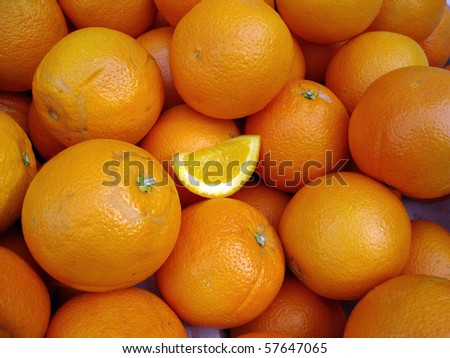 Organic Oranges with a small slice of orange in the middle on display at a farmers market in San Francisco