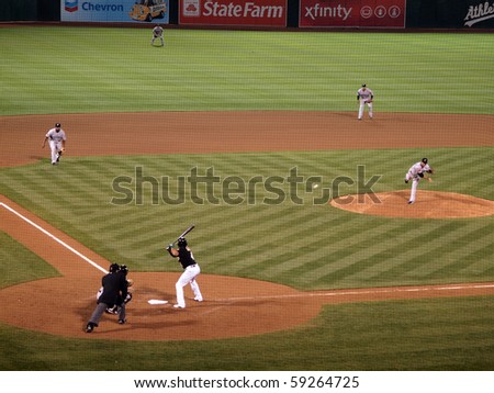OAKLAND, CA - AUGUST 16: Blue Jays vs. Athletics: Pitcher Shaun Marcum throws pitch to Coco Crisp, ball can be seen leaving hand. infield playing in. August 16, 2010 at Coliseum in Oakland California.