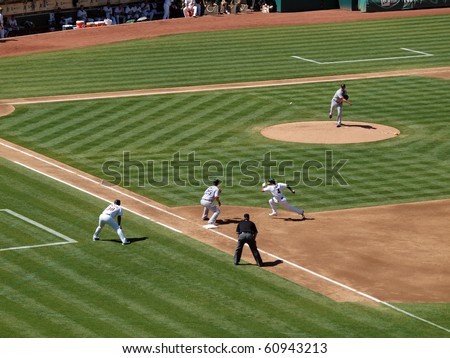 OAKLAND, CA - SEPTEMBER 12: Red Sox vs. A\'s: Josh Beckett throws to 1st baseman Mike Lowell as Coco Crisp runs back to the base.  September 12 2010 Coliseum Oakland California