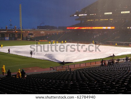 SAN FRANCISCO - APRIL 11: Braves Vs. Giants: Giants grounds crew uses tarp to cover infield to save it from rain after Giants win game April 11 2010 at Att Park San Francisco California.