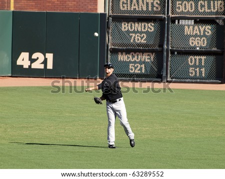SAN FRANCISCO, CA - JULY 28: Giants Vs. Marlins: Marlins Cody Ross throws ball in the outfield to warm up between innings on July 28, 2010 at AT&T Park San Francisco California.