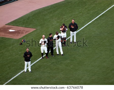 SAN FRANCISCO, CA - OCTOBER 20: Giants vs. Phillies: Giants Players stand with hats removed during National anthem before the start of game four NLCS 2010 October 20, 2010 AT&T Park San Francisco.