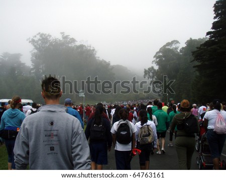 SAN FRANCISCO - JULY 15: long line of people participating to the AIDS Walk 2007 walking down into Golden Gate Park on a foggy day July 15, 2007 in San Francisco.