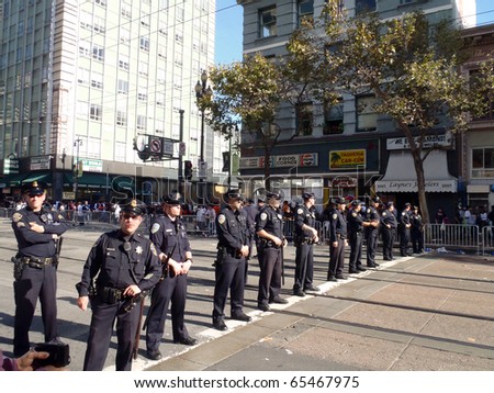 SAN FRANCISCO, CA - NOVEMBER 3: Police officers stand in line across market street keeping the peace after Giants World Series Parade Nov. 3, 2010 San Francisco, CA.